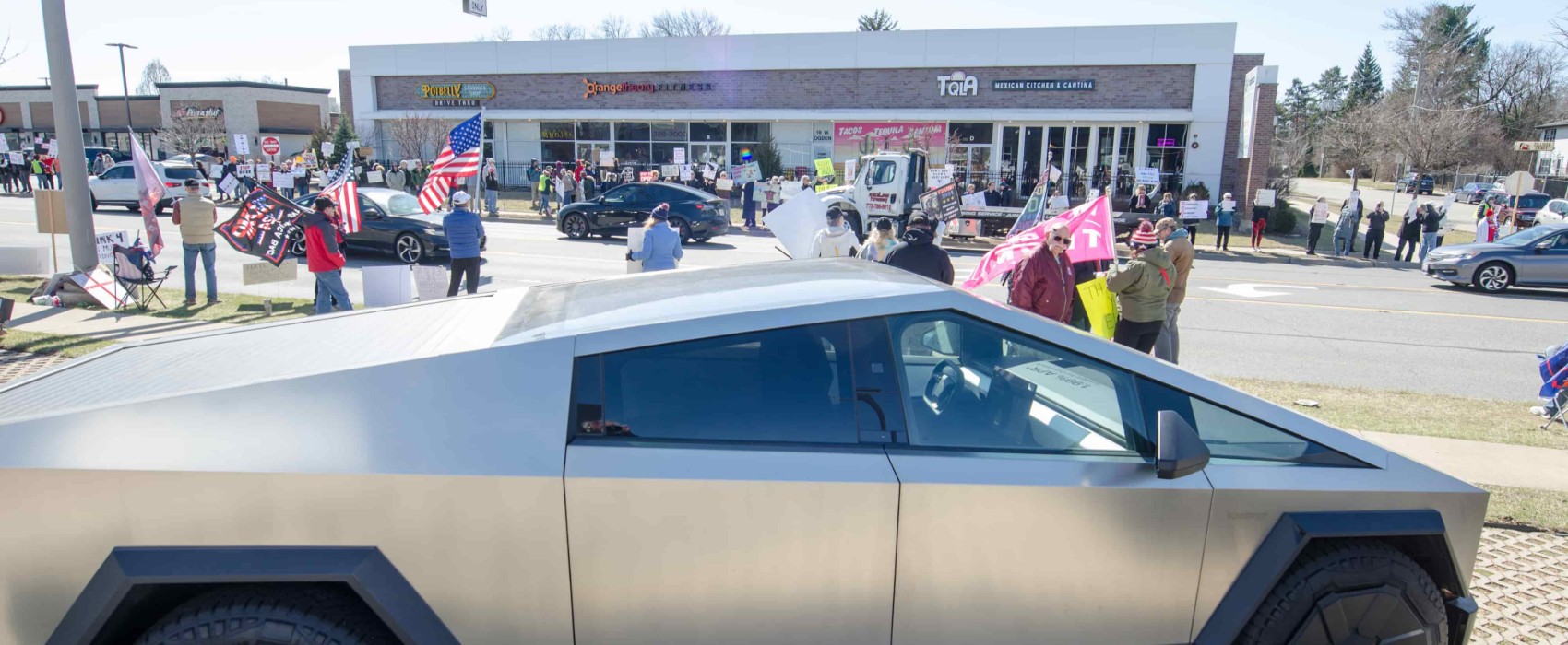 Man Charged for Driving Car Into Tesla Protest